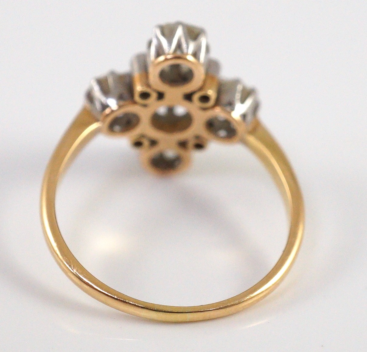 A gold and old cut five stone diamond set 'cross' ring, with diamond chip set spacers
